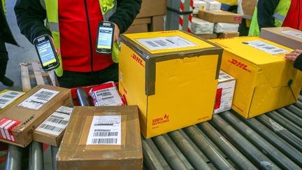 Des colis sont en transit dans un entrepôt de distribution de DHL, à Valence (Drôme), le 12 décembre 2024. (NICOLAS GUYONNET / HANS LUCAS / AFP)